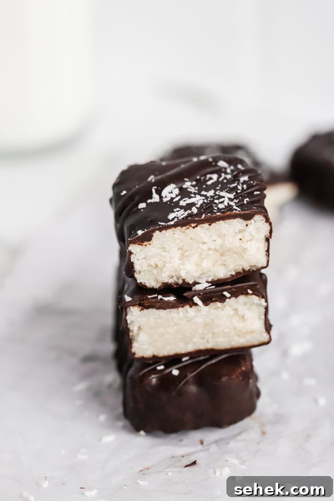 Vegan Coconut Bounty Bars Recipe — 6 Ingredients, No Bake 6 close up shot of stacked creamy and delicious chocolate bounty bars