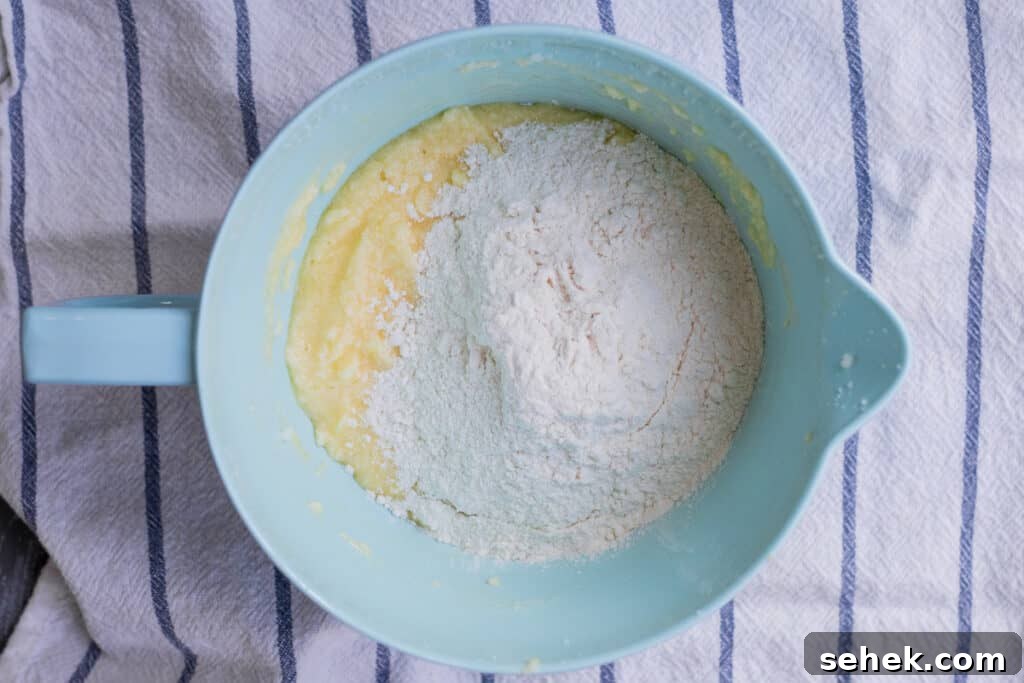 Lemon-Infused Blueberry Muffins Recipe 6 flour on top creamed butter and sugar in mixing bowl