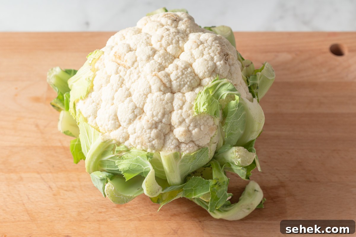 Crispy Air Fryer Cauliflower Steaks with Garlic Herb Sauce 3 cauliflower on a cutting board.
