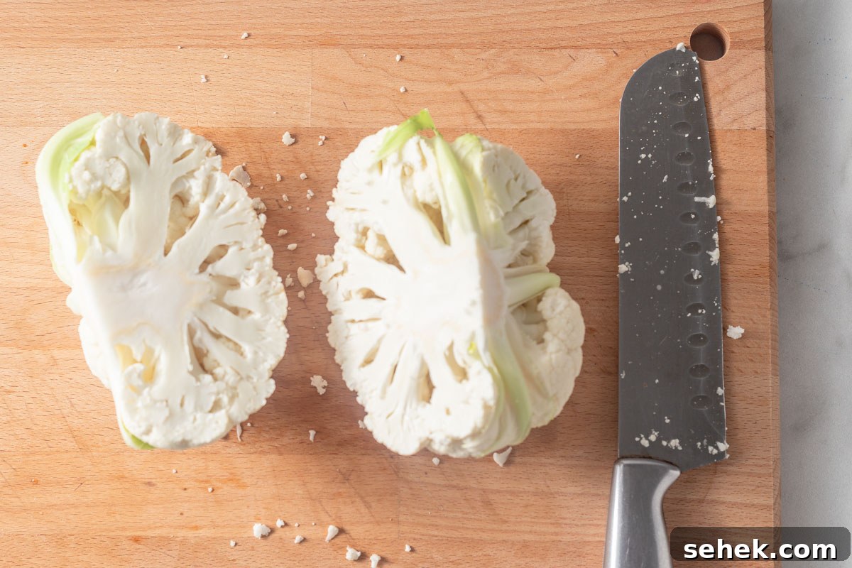 Crispy Air Fryer Cauliflower Steaks with Garlic Herb Sauce 5 cutting cauliflower into two with a sharp knife.