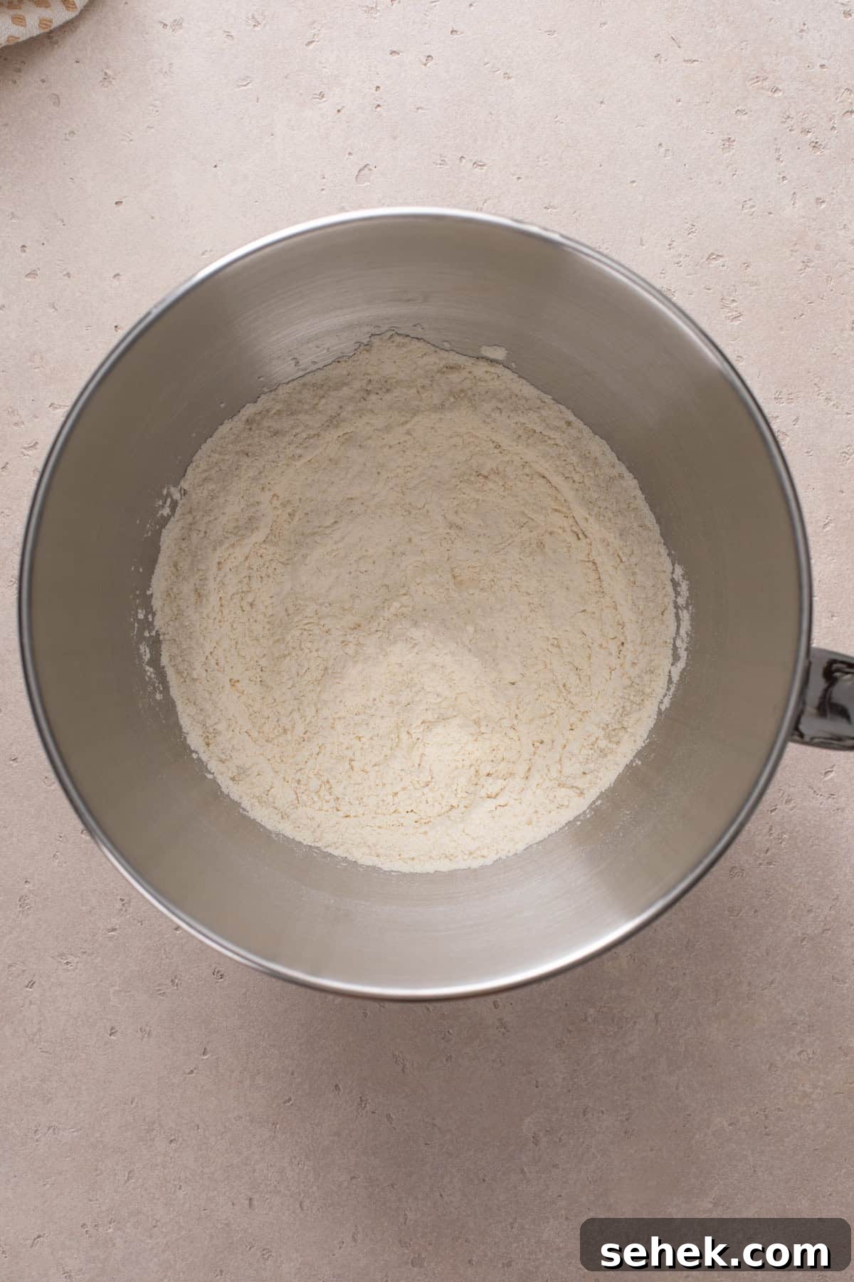 Dough base for potato bread mixed in a steel bowl.