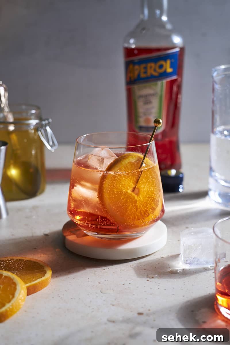 Aperol Soda Cocktail Recipe: Refreshing Italian Spritz Alternative 2 Aperol Soda in a cocktail glass garnished with an orange slice.