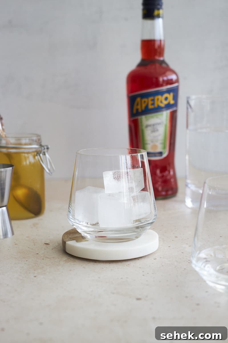 Aperol Soda Cocktail Recipe: Refreshing Italian Spritz Alternative 4 Ice cubes in a cocktail glass.