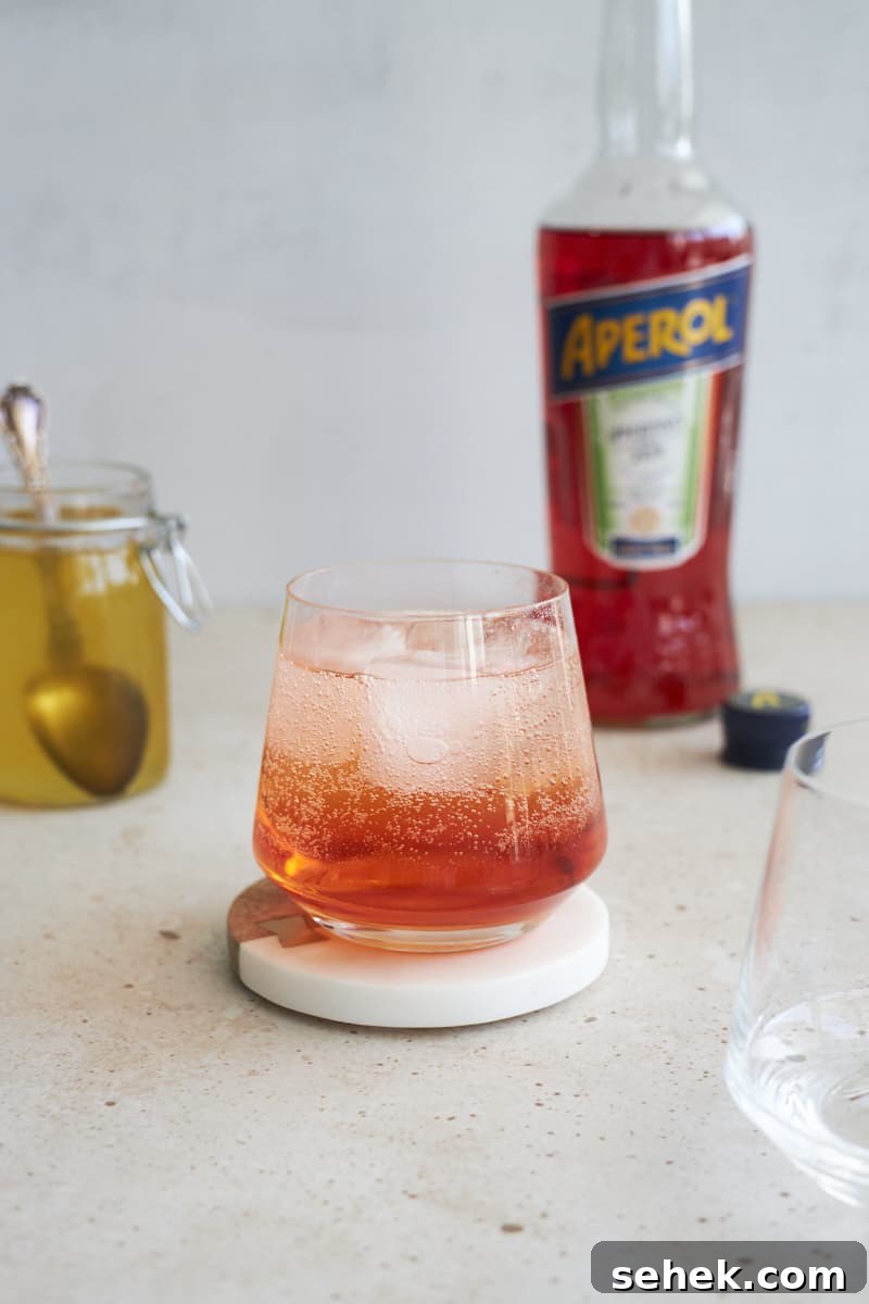 Aperol Soda Cocktail Recipe: Refreshing Italian Spritz Alternative 7 Cocktail topped with club soda.