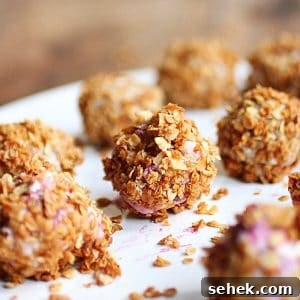 Ice Cream–Filled Granola Truffles: No-Bake Dessert Bites 8 Several granola ice cream truffles on a white plate.