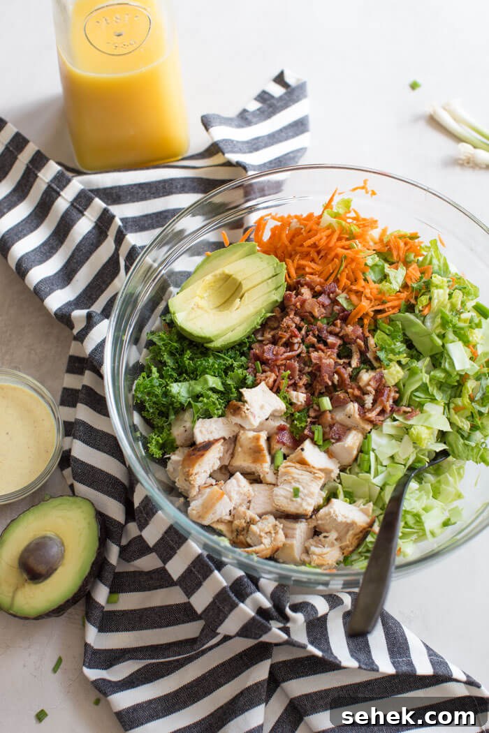 Farmhouse Chopped Chicken Salad with Creamy Herb Dressing 2 Farmhouse Chicken Chopped Salad with romaine, cabbage, kale, carrots, grilled chicken, bacon, sunflower seeds and avocado tossed in a tangy orange honey mustard dressing.