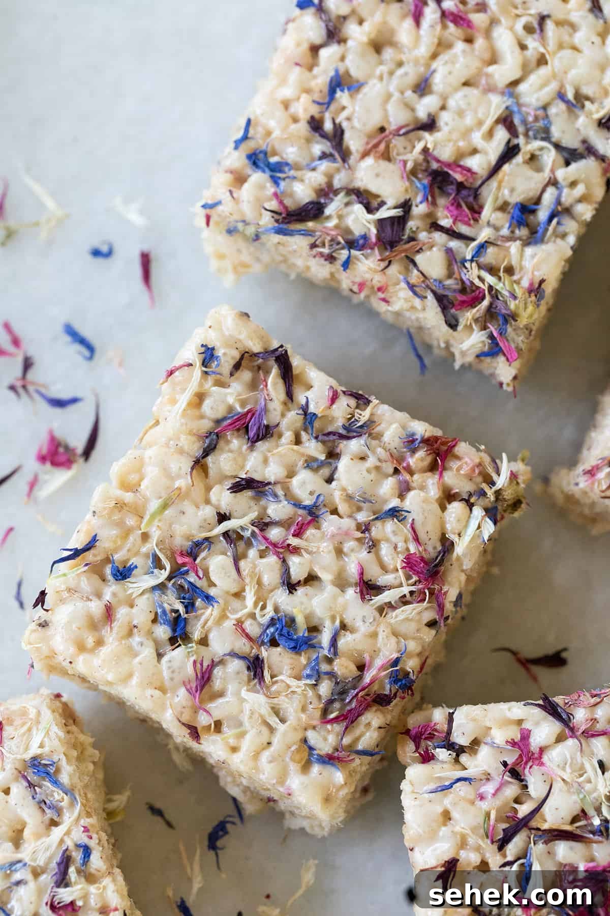 Naturally dyed 4th of July Rice Krispie treats with red, white, and blue petals.