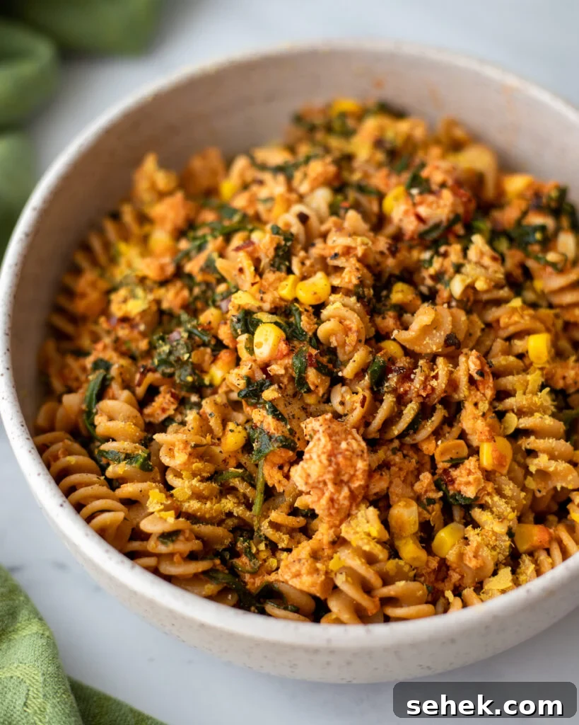 serving bowl with Pasta with Tofu and Veggies, including kale, corn, and more.