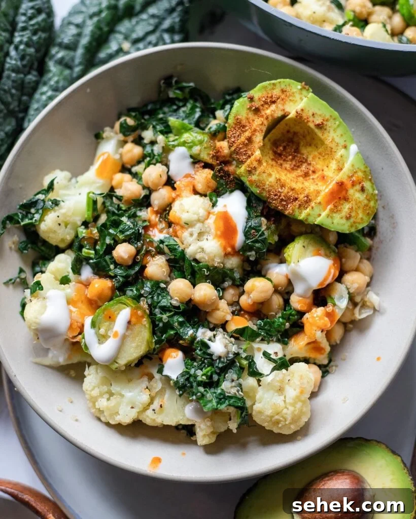 Easy Power Bowl with cauliflower, brussels sprouts, chickpeas, kale, and avocado in a gray bowl.