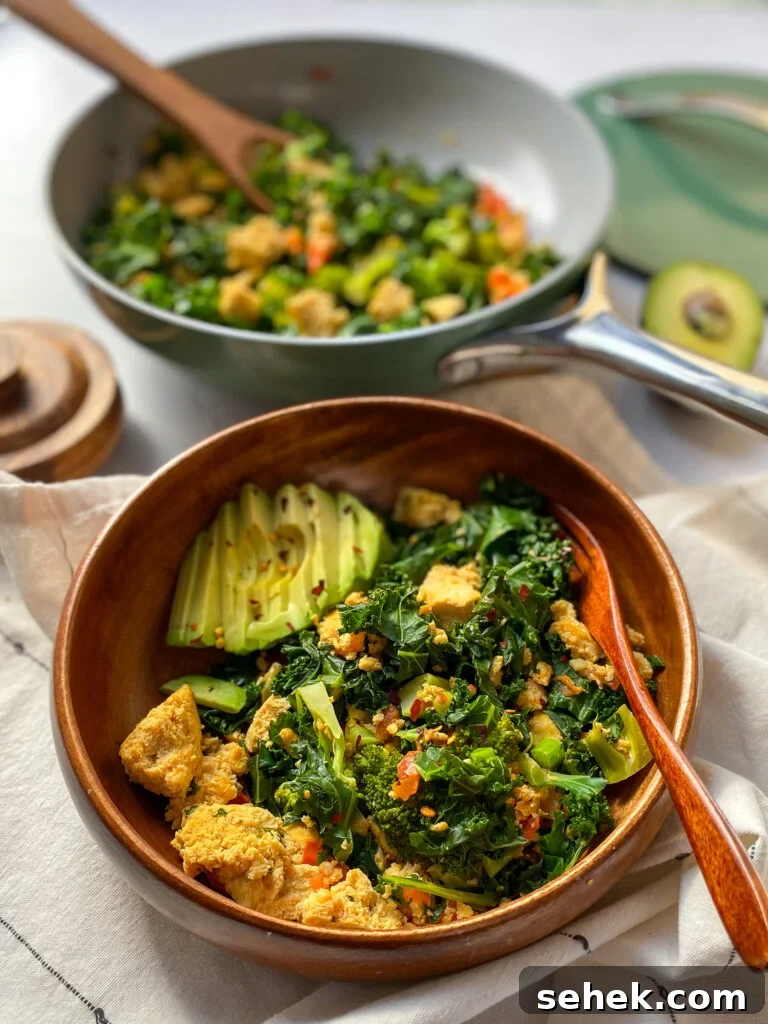 Tofu Scramble with kale in a wooden serving bowl.