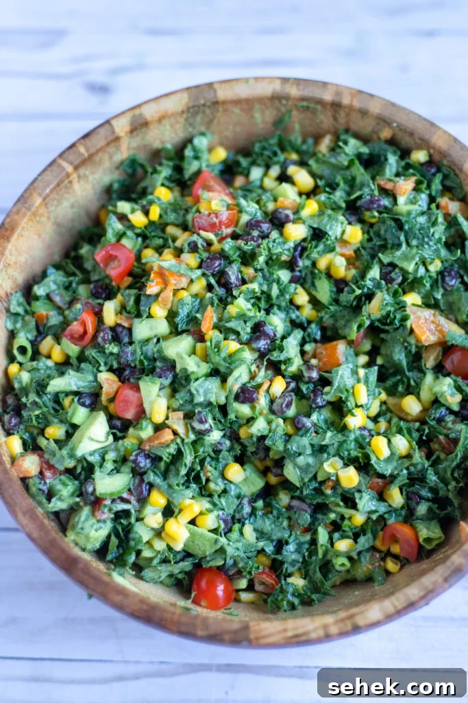 image kale and bean salad in a wooden serving bowl.
