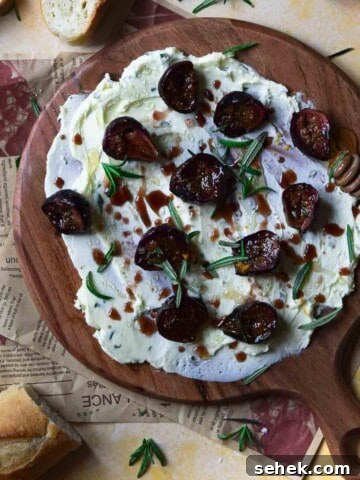 Overhead view of roasted figs on a serving board with butter.