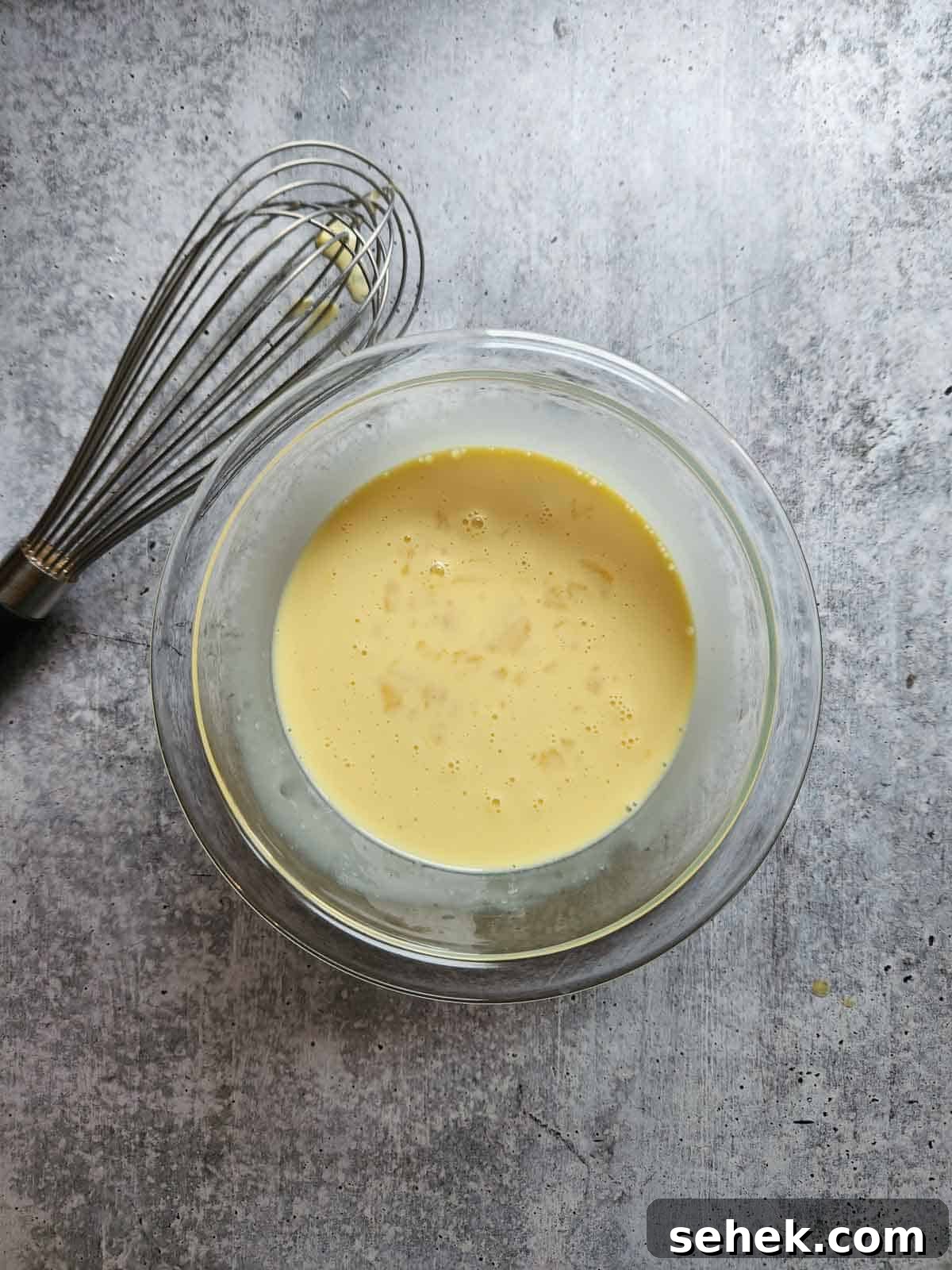 Spiced Eggnog Waffles with Warm Holiday Flavors 5 Wet ingredients in a bowl for eggnog waffles.