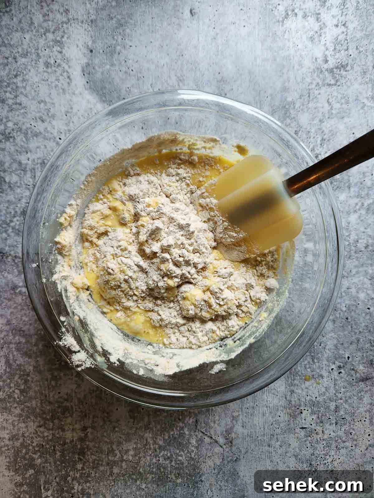 Spiced Eggnog Waffles with Warm Holiday Flavors 6 Mixing wet ingredients and dry ingredients for waffles.
