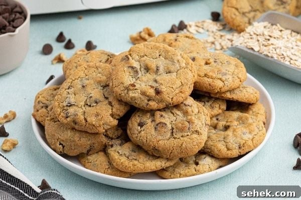 How to Make DoubleTree Signature Cookies in an Air Fryer 2 Cookies stacked on a white plate.