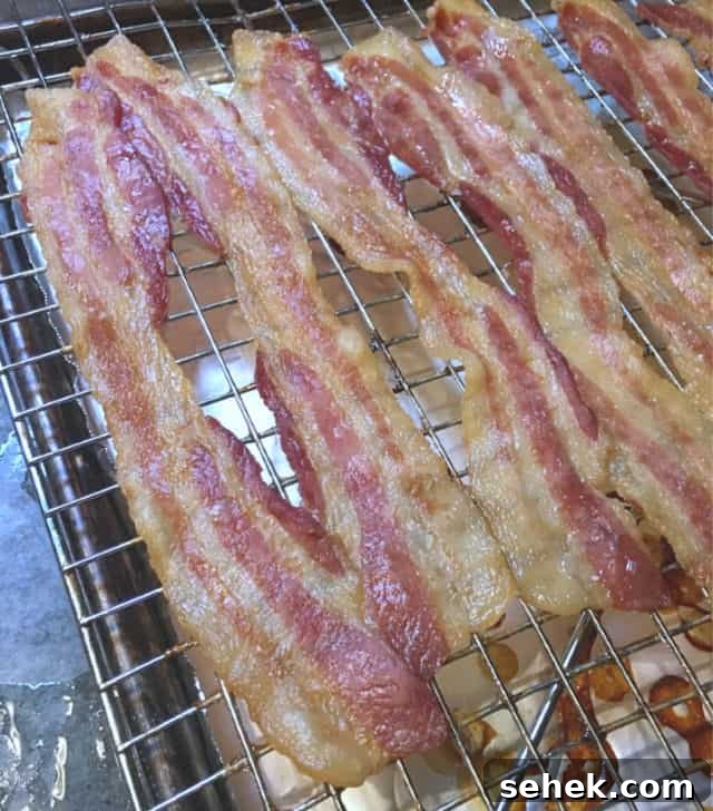 Oven-Baked Bacon on a Rack: Perfect Crispy Strips Every Time 3 A photo of oven cooked bacon on a rack in a pan