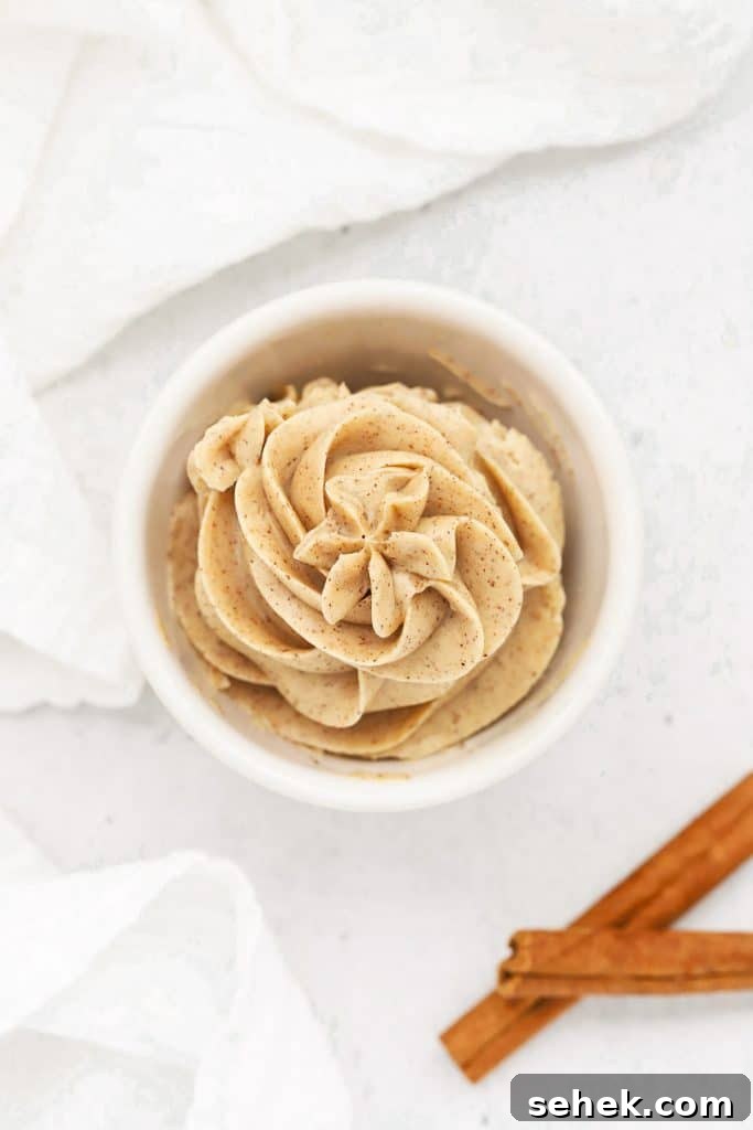 Whipped Honey Butter with Cinnamon — Fluffy Spread Recipe 10 Overhead view of Whipped Cinnamon Butter Piped into a small white bowl in a pretty design