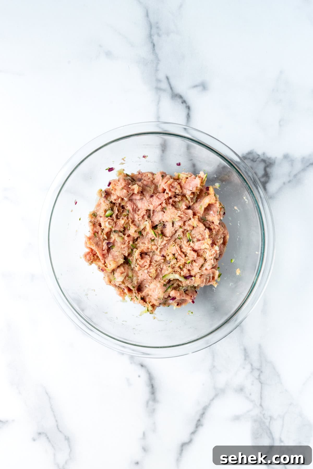 Ground Turkey Meatballs with Zucchini ingredients mixed together in a bowl.