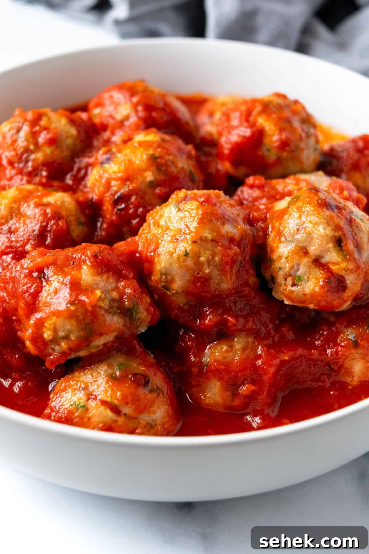 Turkey Zucchini Meatballs with Marinara Sauce in a white serving bowl.