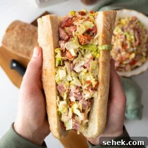 Classic Italian Chopped Sandwich Recipe for a Flavorful Sub 9 Chopped Italian Salad in an Italian sub held by two hands.
