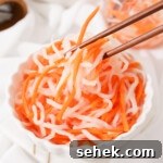 Vietnamese Pickled Carrots & Daikon (Đồ Chua) Recipe 8 Picking up some đồ chua with chopsticks.