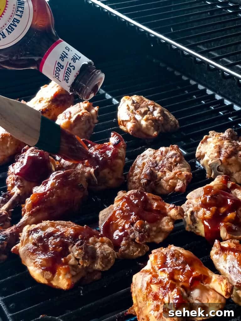 Authentic Amish-Style BBQ Chicken Recipe for Juicy, Smoky Flavor 6 brushing barbecue sauce onto the grilled chicken