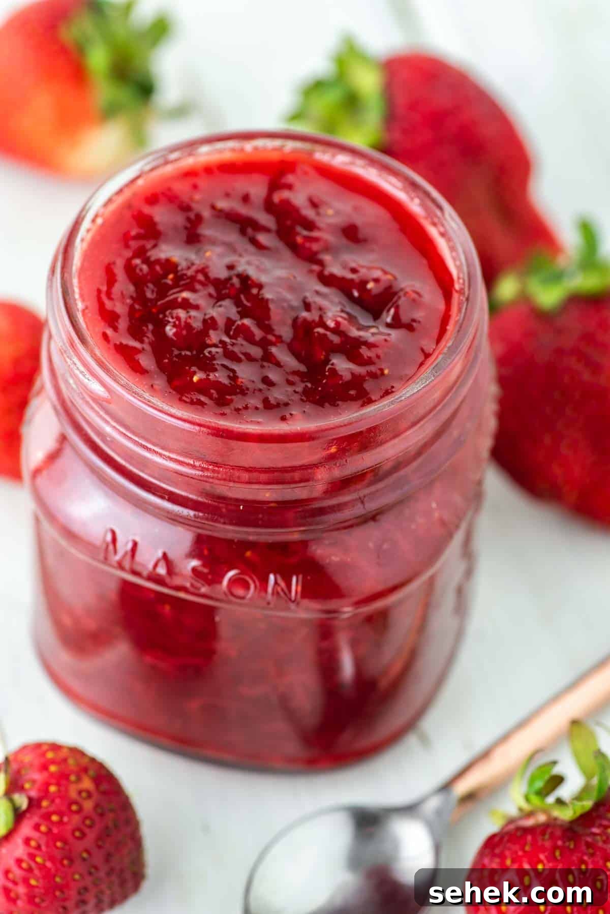 Low-Sugar Strawberry Jam Recipe — Small-Batch Preserving Tips 9 Mason jar filled with low sugar strawberry jam.