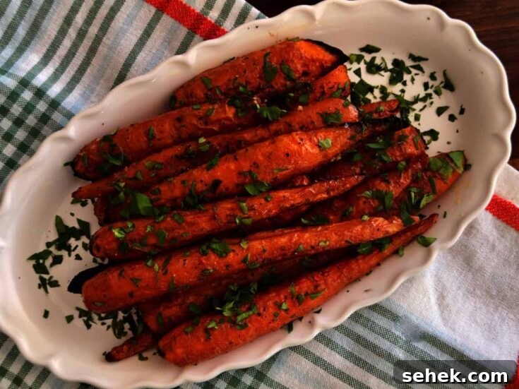 Delicious roasted carrots garnished with fresh herbs, perfect for healthy side dishes or snacks.
