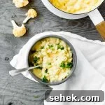 bowl of stovetop cauliflower mac and cheese with parsley garnish