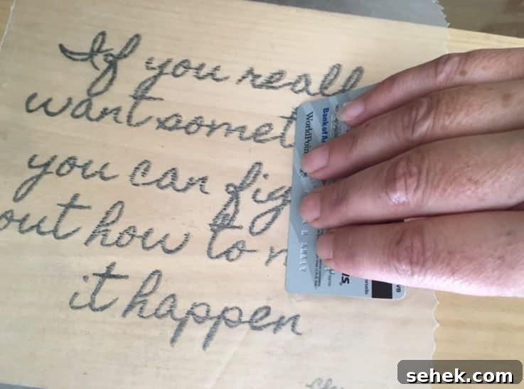 Transfer Photos to Wood: Step-by-Step Photo Transfer Guide 8 Lightly press image onto wood using an old credit card.
