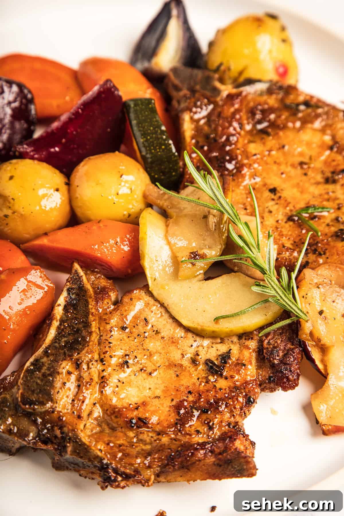A close-up shot of the pork chops and mixed vegetables.