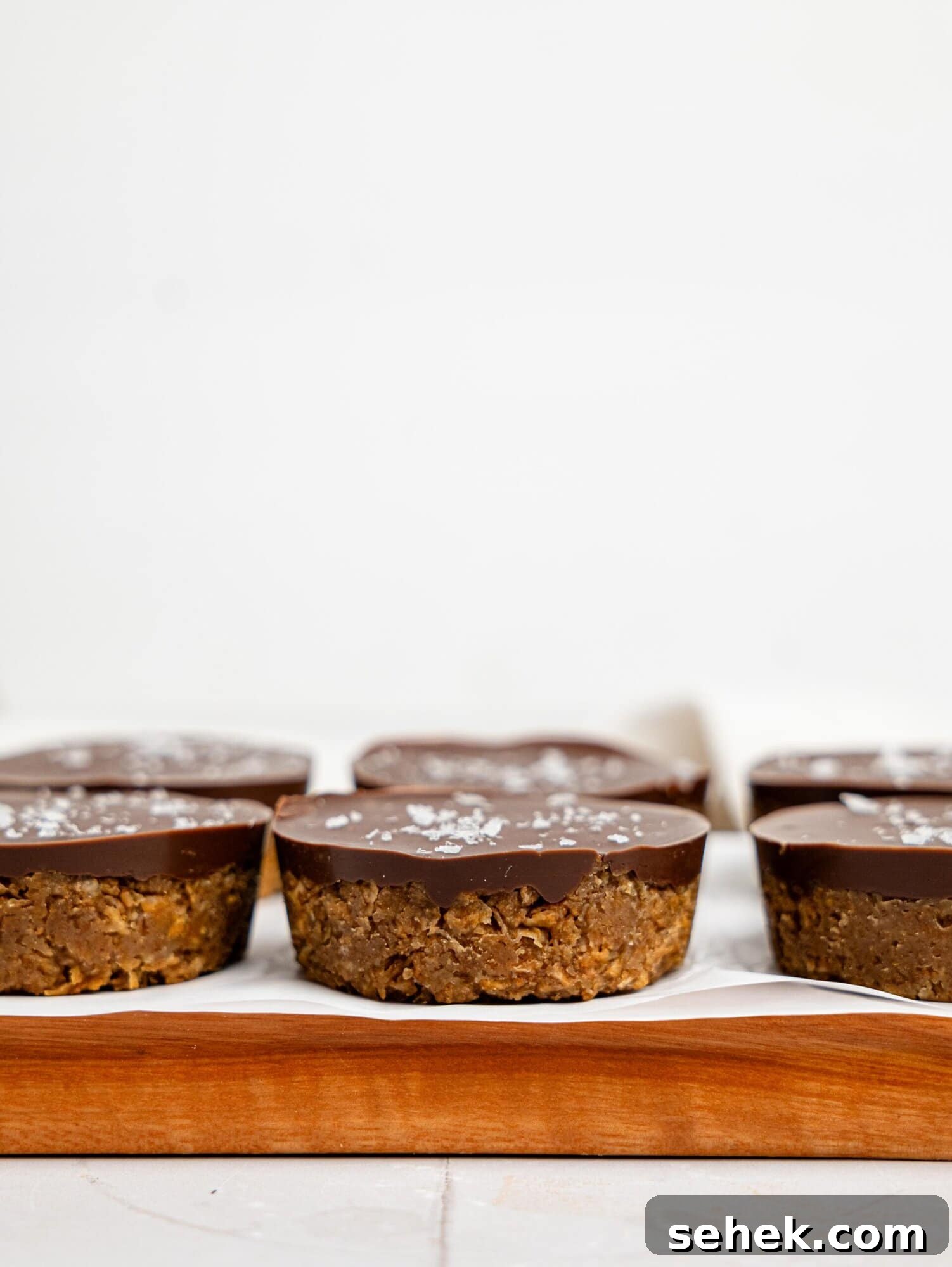 Peanut Butter Weetbix Cups on a wooden cutting board.