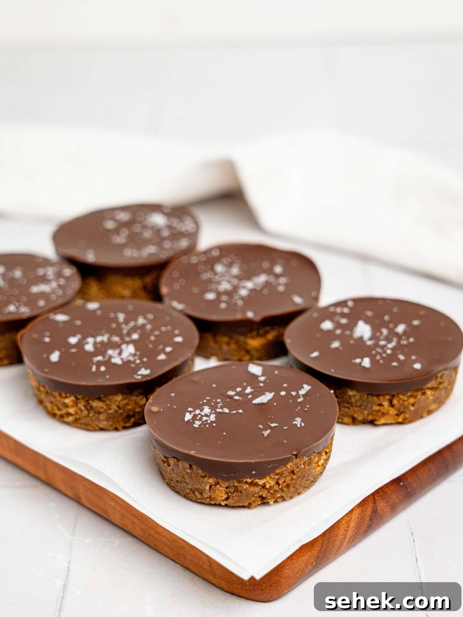 Peanut Butter Weetbix Cups on a wooden cutting board.