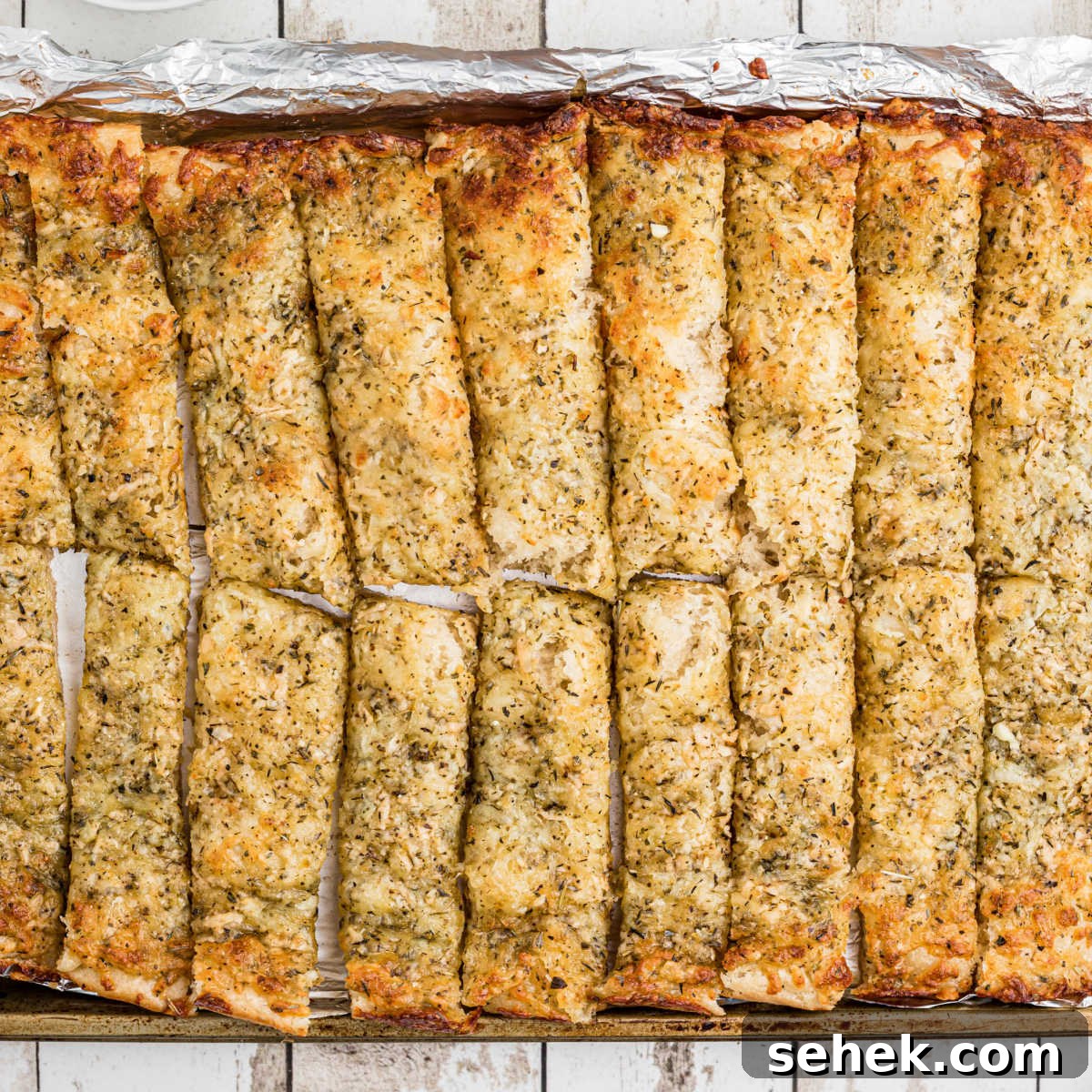 28 Delicious Sides to Serve with Jambalaya 25 An overhead shot of a pan full of little caesars italian cheese bread recipe.