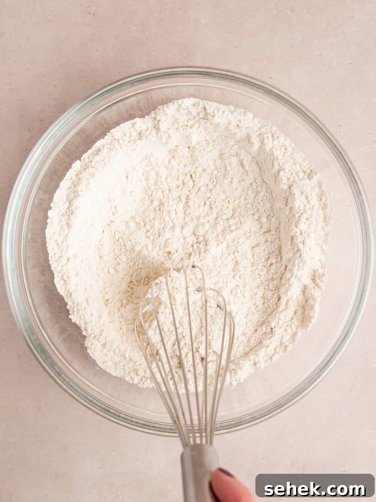 Homemade Belgian Waffles Recipe for Crispy, Fluffy Results 4 Whisking flour, baking powder, baking soda, sugar, and salt in a bowl.