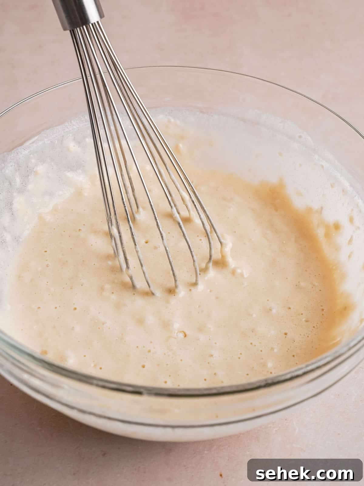 Homemade Belgian Waffles Recipe for Crispy, Fluffy Results 6 Whisking waffle batter in a bowl.