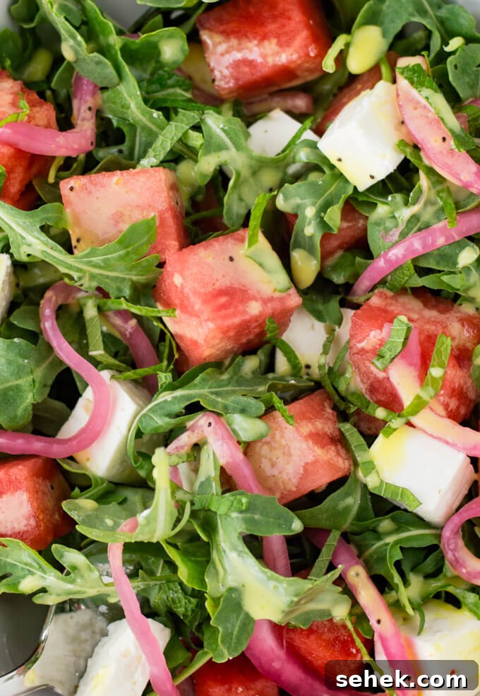 Watermelon Arugula Salad with Feta & Mint 6 Watermelon salad with pickled onions, feta cheese and arugula.