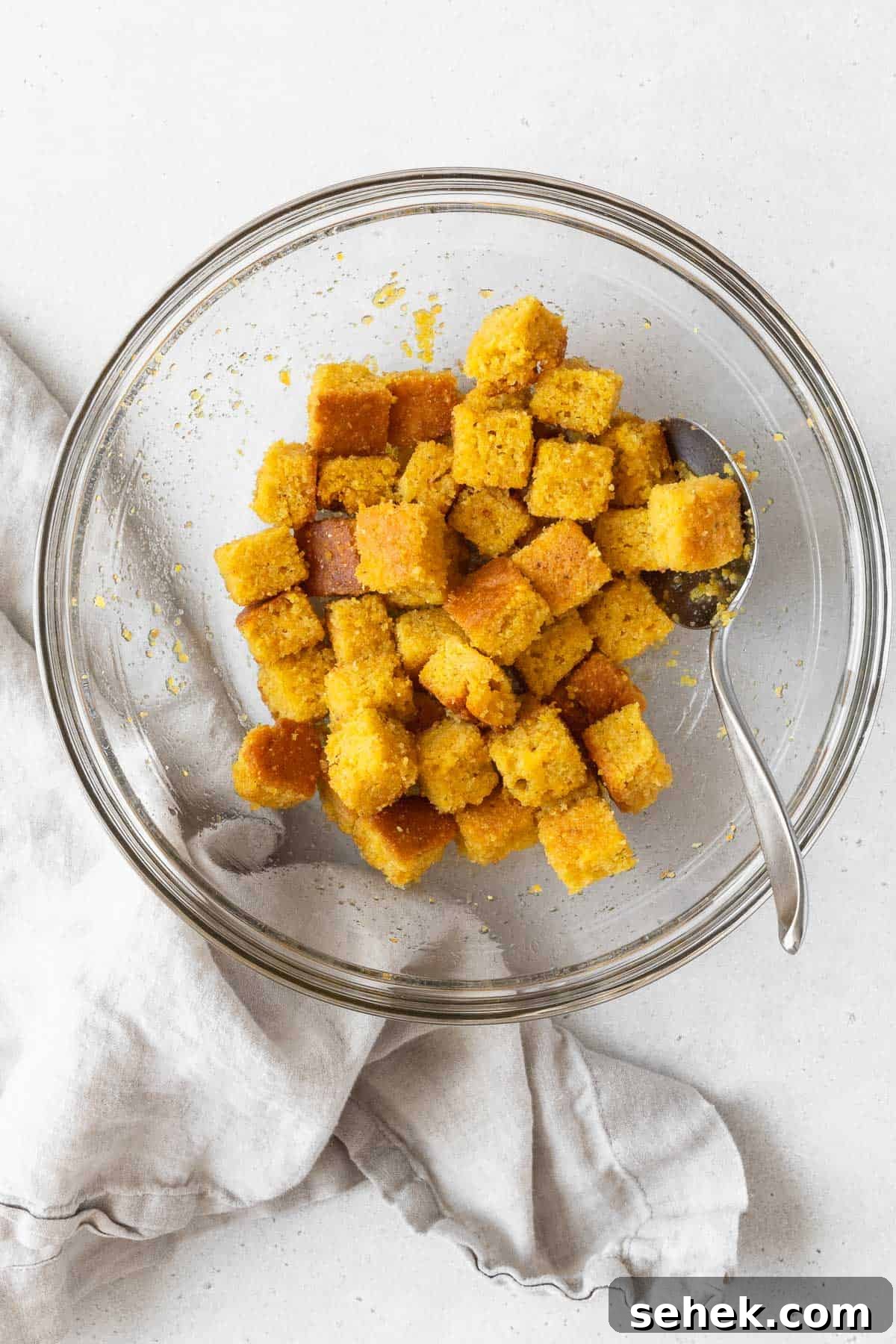 Crispy Cornbread Croutons for Salads and Soups 12 A large mixing bowl of the corn bread croutons before baking.