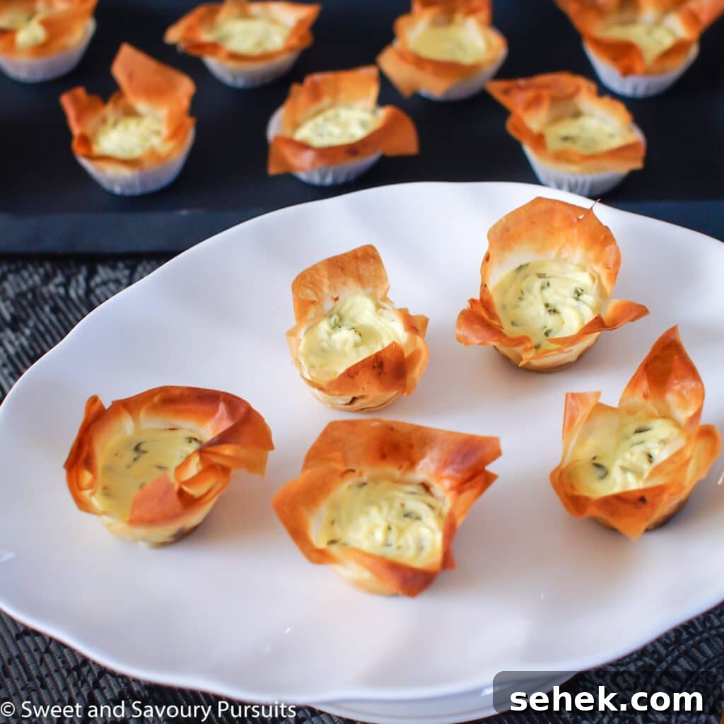 Caramelized Onion & Goat Cheese Phyllo Tartlets 2 Caramelized Onion and Goat Cheese Phyllo Tartelettes on dish.