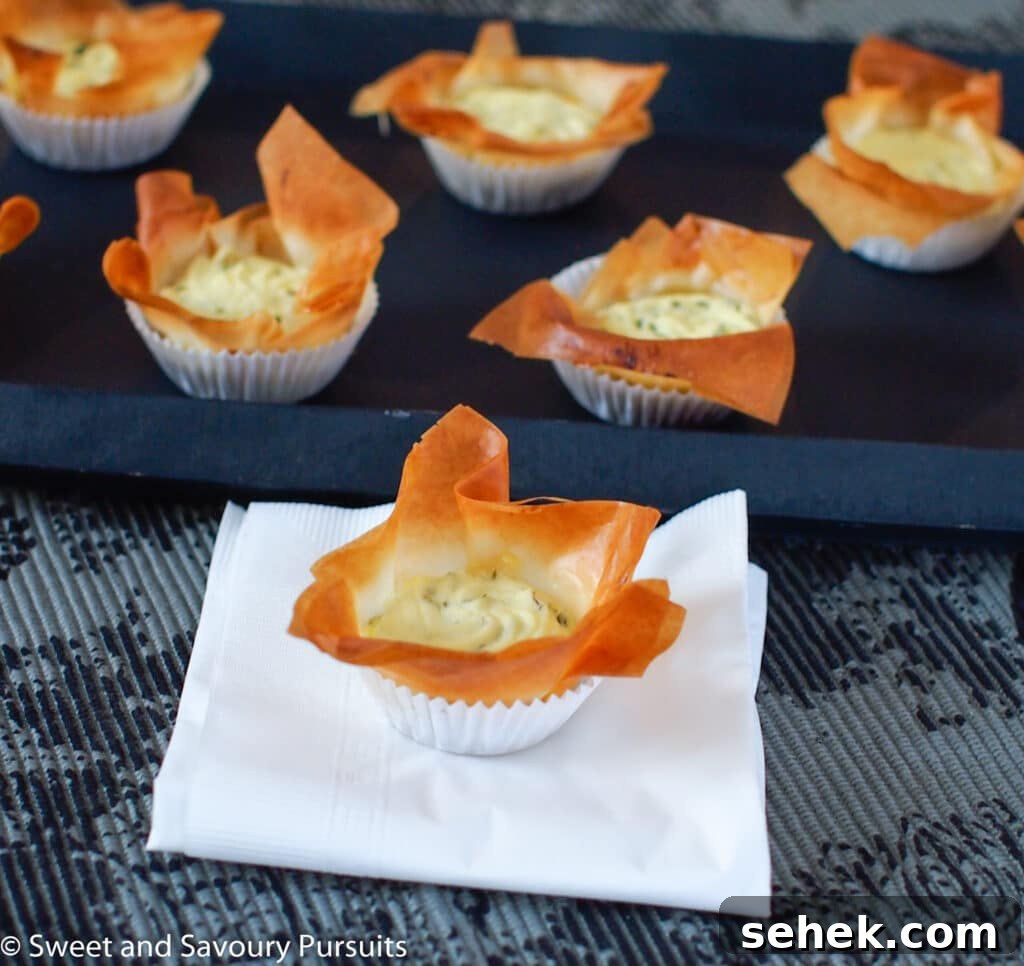 Caramelized Onion & Goat Cheese Phyllo Tartlets 3 Caramelized Onion and Goat Cheese Tartelette on napkin.