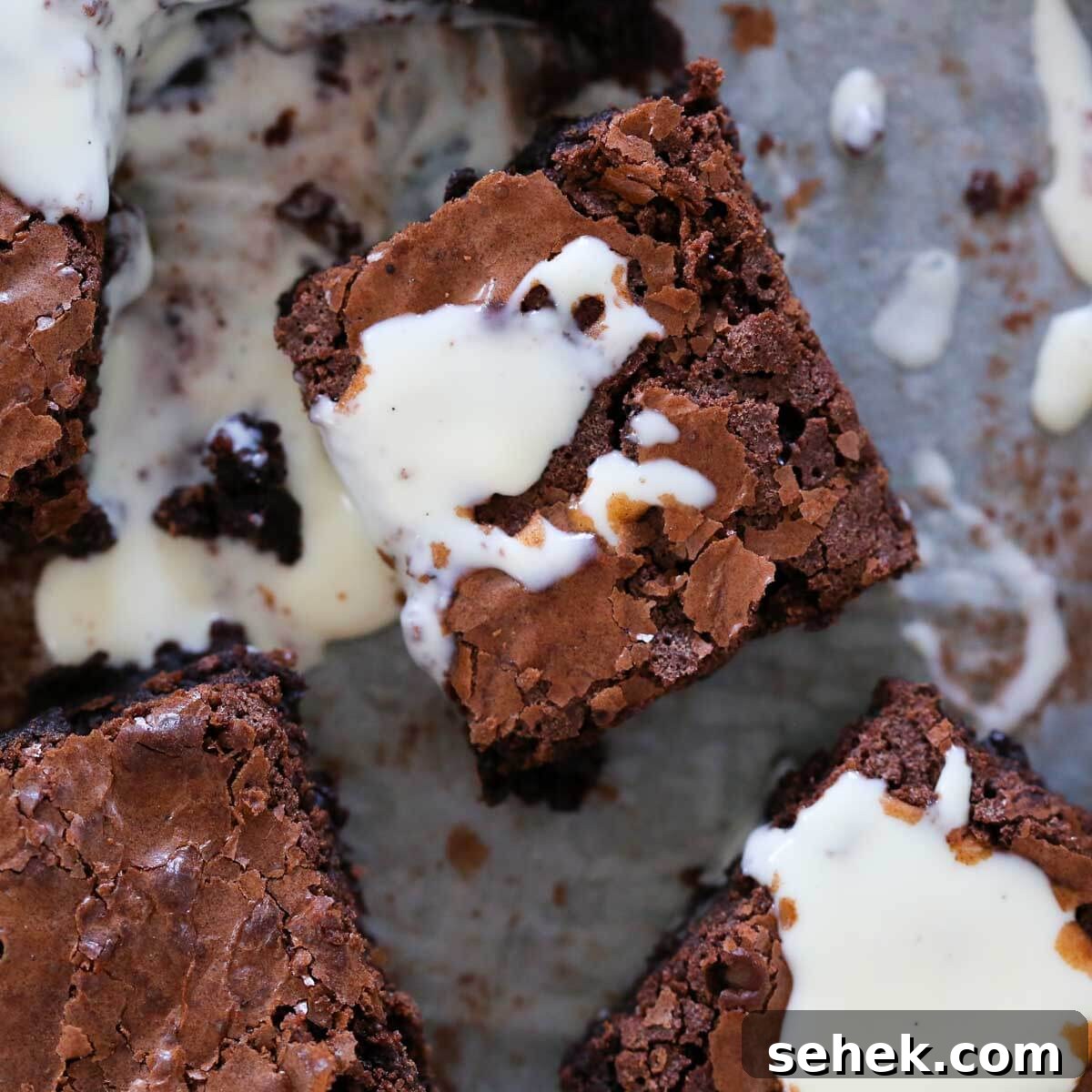 Classic Vanilla Crème Anglaise: French Custard Sauce 4 brownies on parchment with anglaise on top.
