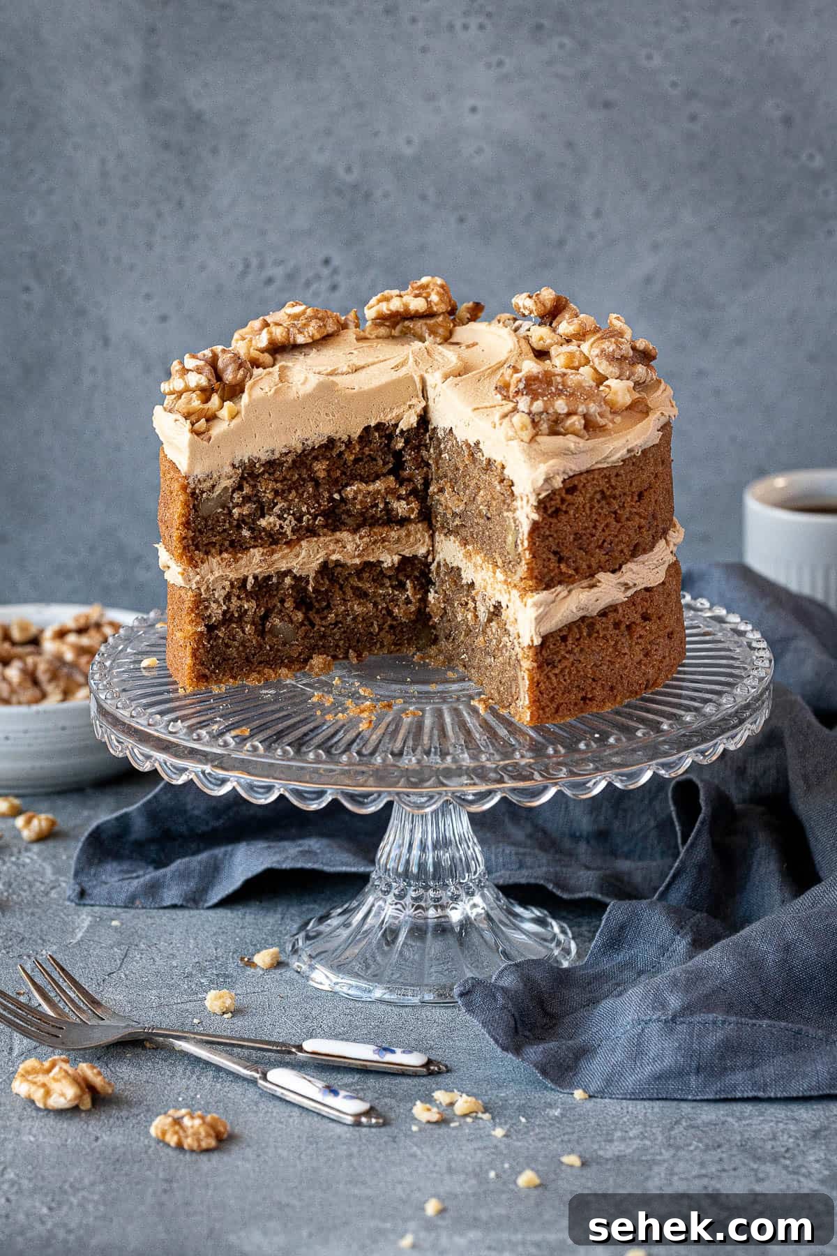 Vegan Gluten-Free Coffee and Walnut Cake Recipe 14 The sliced coffee and walnut cake on a glass cake stand.