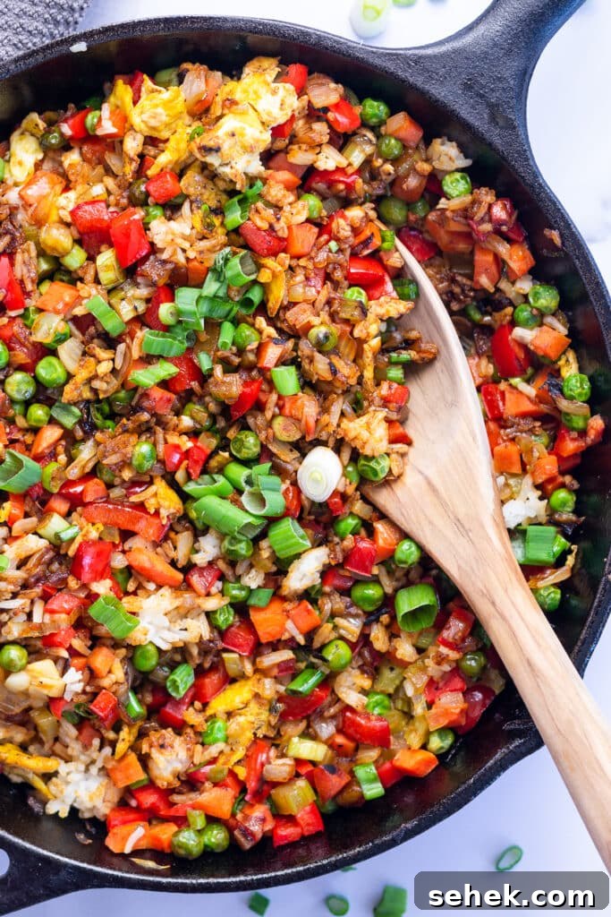 15-Minute Gochujang Fried Rice Recipe 4 Cast iron skillet with gochujang fried rice studded with tons of veggies, scrambled egg and green onions