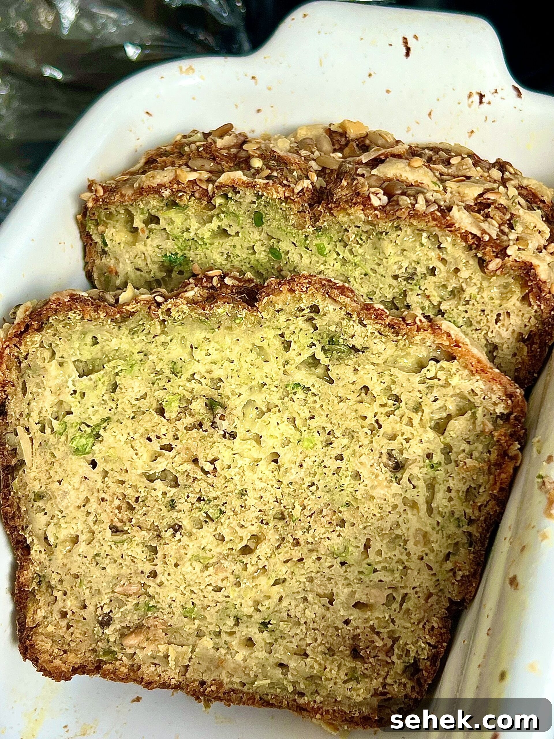 High-Protein Broccoli Bread Recipe 5 Broccoli and spelt flour bread in a white ceramic dish.