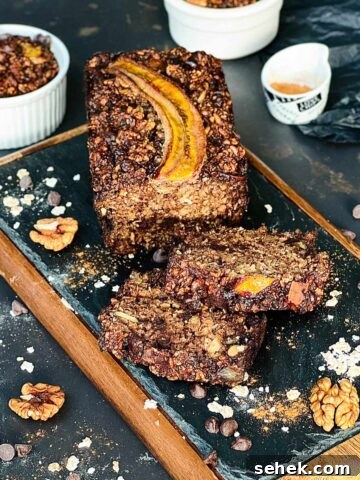 Banana bread with two slices close to the loaf