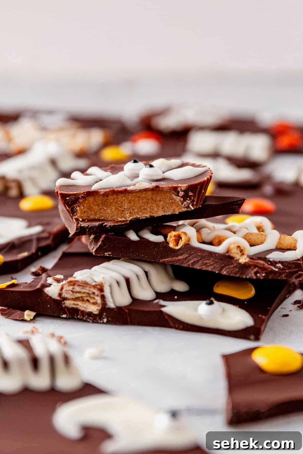 How to Make Spooky Halloween Candy Bark 11 three pieces of broken halloween bark stacked on a counter