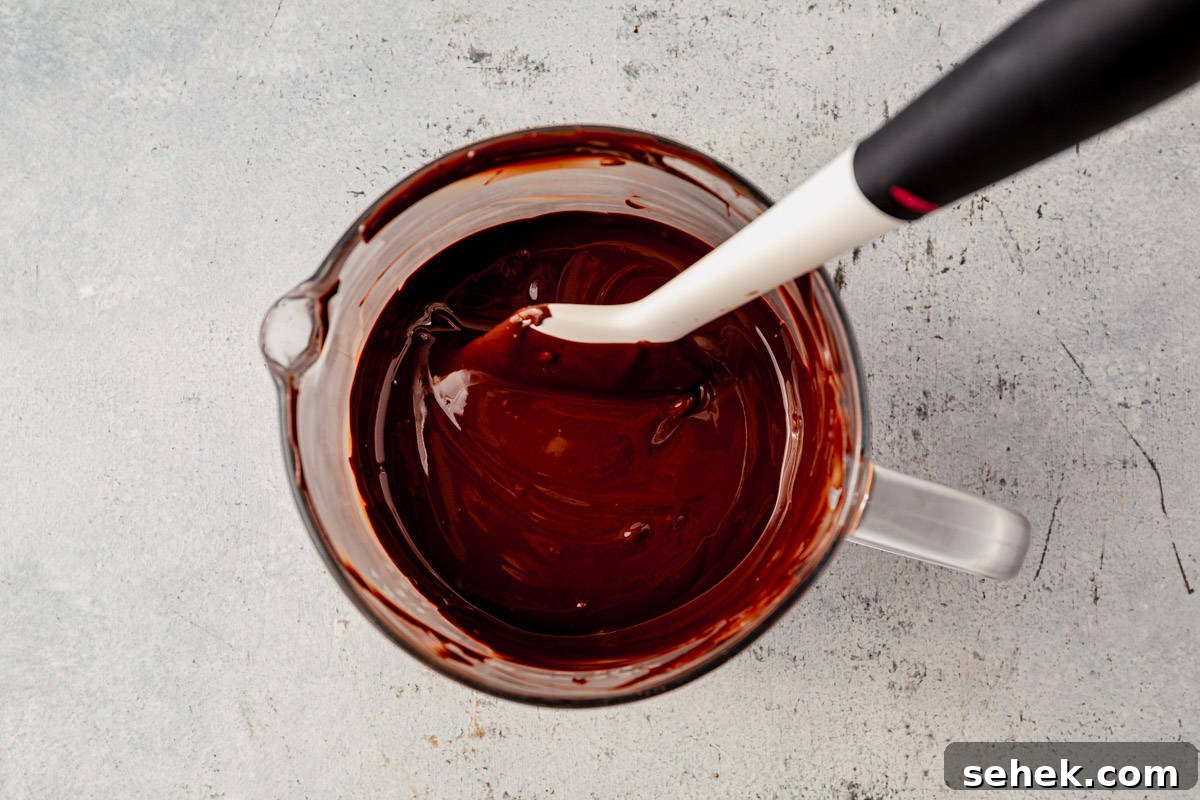How to Make Spooky Halloween Candy Bark 4 melted semi-sweet chocolate in a bowl