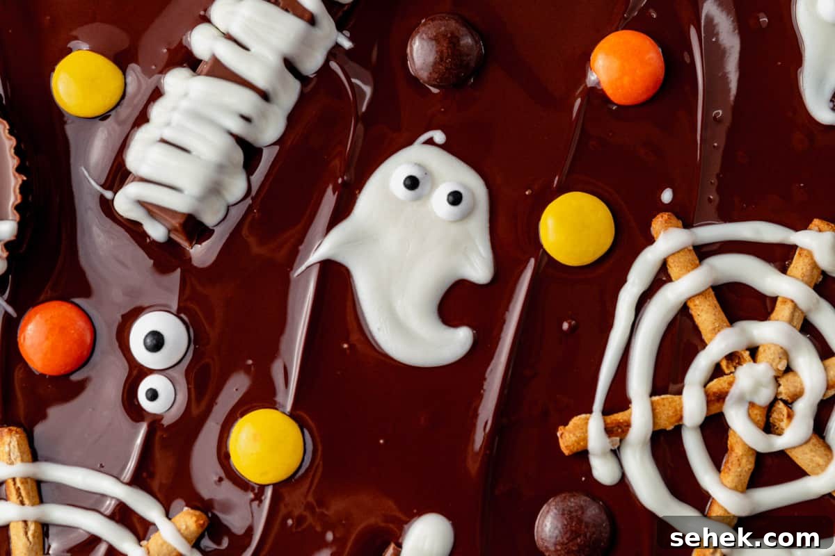 How to Make Spooky Halloween Candy Bark 5 white chocolate ghost with candy eyes on melted chocolate