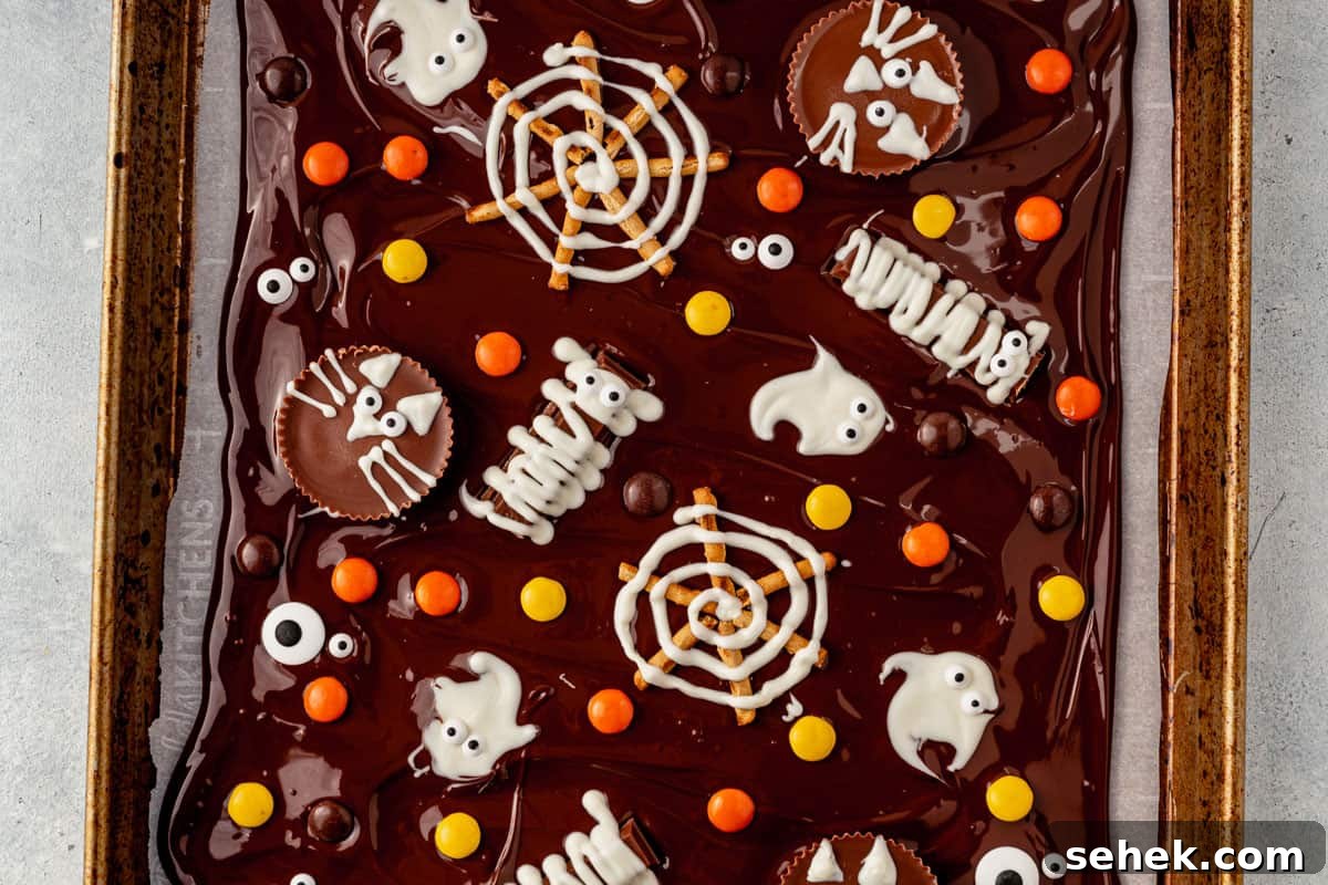 How to Make Spooky Halloween Candy Bark 9 halloween bark decorated with halloween candy, ghost, spiderwebs, and mummies