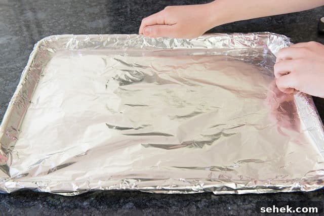 Crispy Oven Bacon: How to Bake Bacon for Even Crispness 4 Lining Sheet pan with Aluminum Foil for Cooking Bacon in the Oven